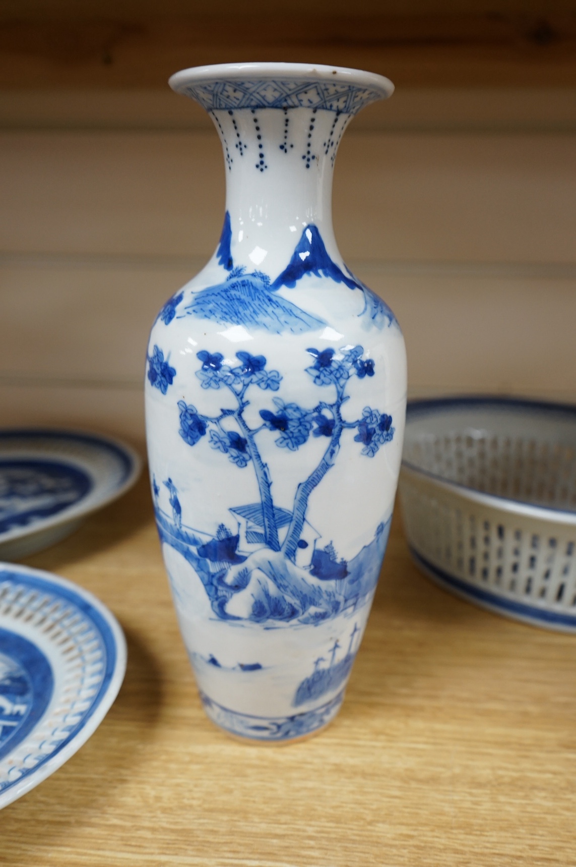An early 19th century Chinese export blue and white chestnut dish, two related stands and a similar vase, largest 26cm high. Condition - fair